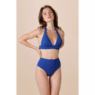 worn high-waisted for a pin-up girl silhouette. To reveal feminine curves with charm, their waistband can be folded over the hips to create low-waisted bikini bottoms